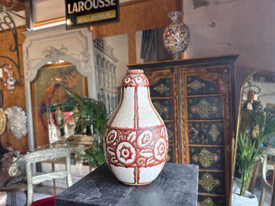 a vase sitting on top of a table in a room