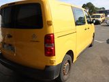 a yellow van that is parked in a parking lot