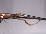 an old rifle with a wooden barrel and a leather case