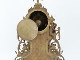 a clock that is sitting on a stand with a clock on it