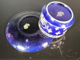 a blue vase sitting on top of a black table