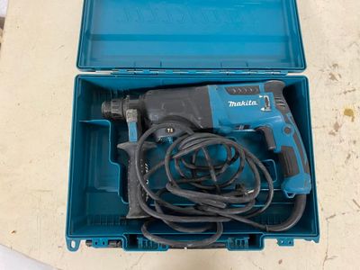 a blue box with a drill and a cord in it
