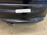 the rear end of a car with a sticker on it ' s bumper