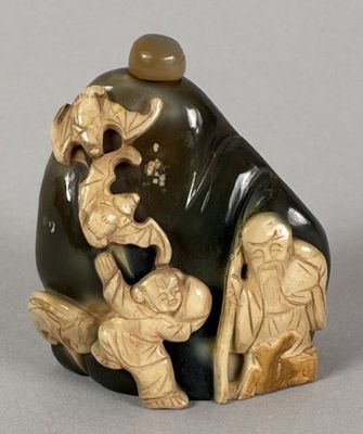 a statue of a man and a woman sitting on a rock