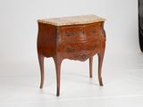 a small chest of drawers with a marble top