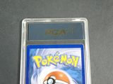 the pokemon card is in a clear plastic holder on a table