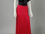a red pleaed skirt with a black top and black top