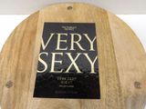 a very sexy book sitting on top of a wooden table