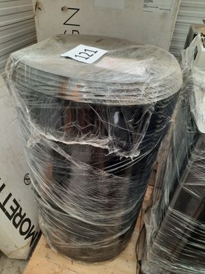many rolls of plastic wrapped around a toilet in a warehouse