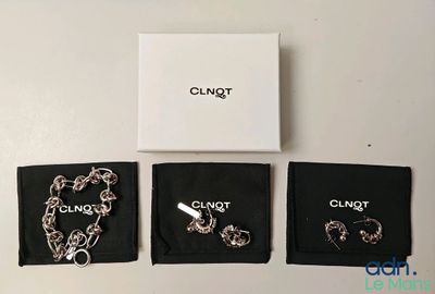 deux bijoux posés sur une table, à côté d'une boîte