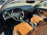 dashboard of a car with leather seats and steering controls