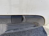 a close up of a car ' s bumper with a small hole in it