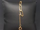 a black pillow with a gold chain and a gold clasp on it