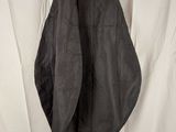 black leather jacket hanging on a clothes rack against a white backdrop