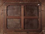 an old window with a wooden frame on the wall
