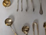 a lot of silver spoons and spoon spoons on the table
