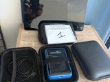 une table sur laquelle se trouvent un ordinateur portable, un téléphone portable et d'autres appareils électroniques