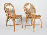 pair of wicker chairs on white background with white backdrop