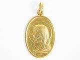 une pièce d'or sur laquelle figurent une femme et un enfant