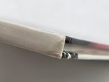 someone is using a pair of scissors to cut the edge of a piece of paper