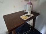 a table with a lamp and a book on it