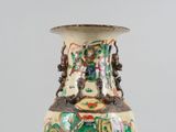 a vase with a design on it sitting on a table