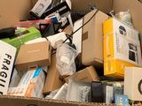 a cardboard box full of electronic devices and other items