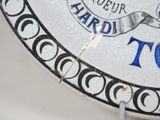 a close up of a plate with a clock on it