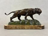 bronze sculpture of a tiger on a rock on a white background