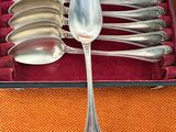 silverware in a red case on an orange table cloth