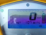 a yellow motorcycle with a digital display on the back of it
