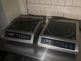 two burners sitting on top of a stove in a kitchen