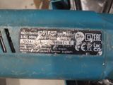 a close up of a blue drill with a sticker on it