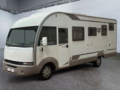 une photo d'un petit camping-car garé dans un garage