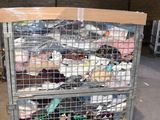 a metal cart with many items in it in a warehouse