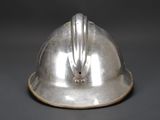 a silver helmet that is sitting on a table