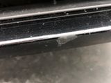 a close up view of a car ' s bumper with scratches on it