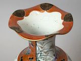 a vase with a floral design on it on a table