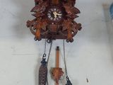 a clock that is hanging on the wall next to other items