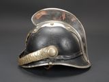 an old helmet with a metal handle on a black background