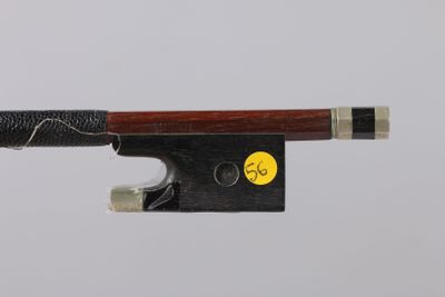 a violin bow that is attached to a piece of wood