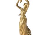 bronze figurine of a woman holding a pot on her head