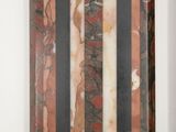 two pieces of marble on display on a white surface