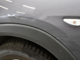 a close up of a car ' s front fender with a sticker on it