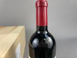 a bottle of wine sitting on a table next to a box