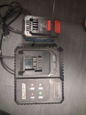 two batteries and a charger on a table