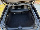 a trunk of a car that is open on the side of the road