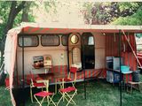 an image of a camper trailer with a table and chairs