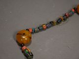 a close up of a necklace with beads and beads on it
