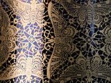 a close up of a blue and gold bowl on a table